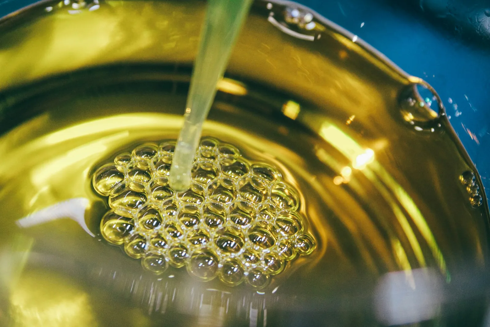 Golden refined oil flowing into a vessel